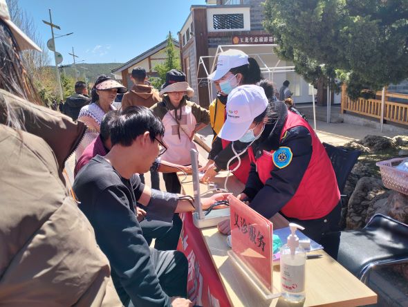 玉龙雪山五一旅游秩序井然 志愿者红马甲成亮丽风景线2.jpg