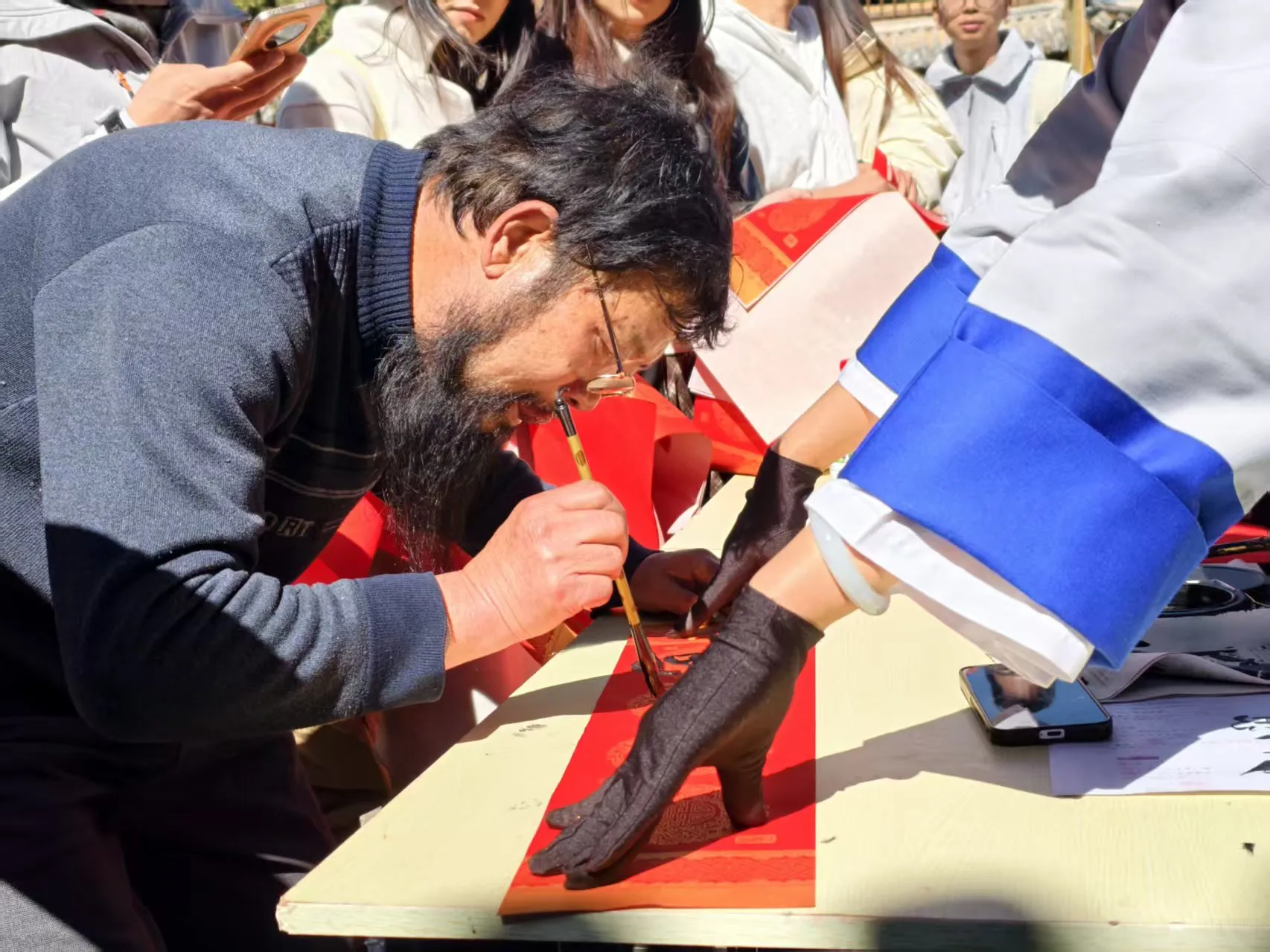 丽江古城年味拉满！东巴文春联免费写，游客排队打卡